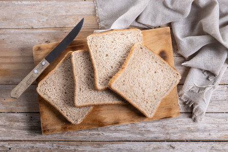 Healthy wholemeal bread slices on wooden table
