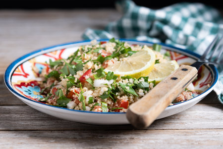 Tabbouleh salad with couscous on wooden tableの写真素材