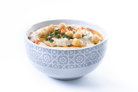 Chickpea hummus with olive oil, parsley and paprika in bowl isolated on white backgroundの写真素材