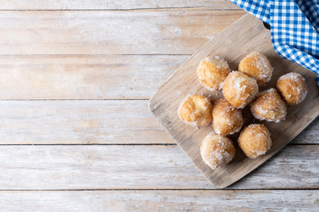 Traditional Carnival fritters or buÃ±uelos de viento on wooden table. Top view. Copy spaceの写真素材