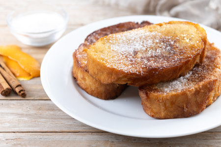 Traditional Spanish torrijas for Holy Week on wooden table. French Toast.