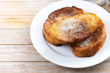 Traditional Spanish torrijas for Holy Week on wooden table. French Toastの写真素材