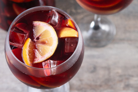 Refreshing Summer Citrus Fruit Sangria in crystal jar on wooden tableの写真素材