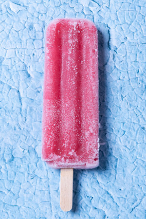 Strawberry popsicles on blue background