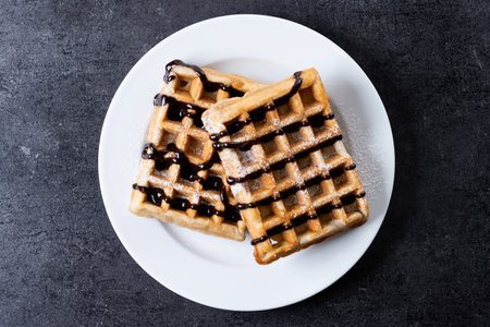 Belgian Waffles with chocolate on black slate background