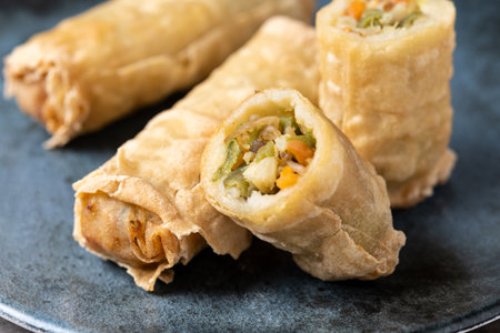 Crispy Spring Rolls on Ceramic Plate on wooden table