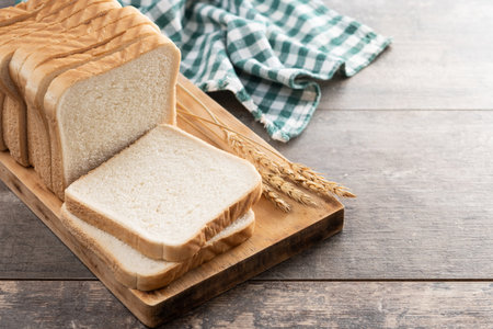 Slices of White Bread on wooden tableの写真素材