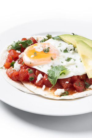 Huevos Rancheros isolated on white background. Traditional Mexican breakfastの写真素材