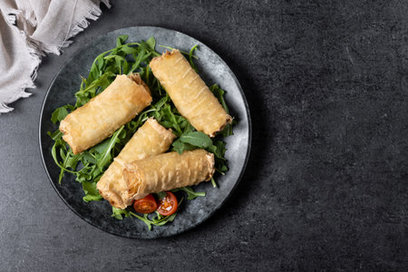 Crispy vegetables spring Rolls on black slate background