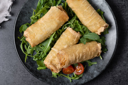 Crispy vegetables spring Rolls on black slate backgroundの写真素材