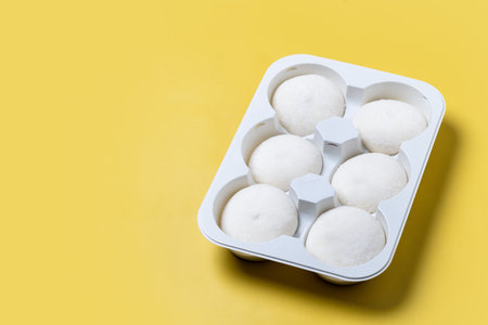 Japanese Coconut ice cream mochi on yellow background.の写真素材