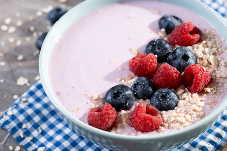 Healthy smoothie bowl with berries on wooden tableの写真素材
