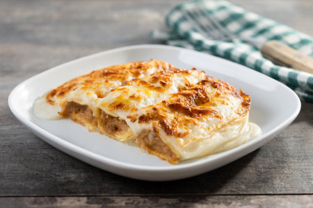 Baked Cannelloni with Cheese and BÃ©chamel Sauce on wooden tableの写真素材