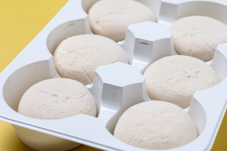 Japanese Coconut ice cream mochi on yellow backgroundの写真素材