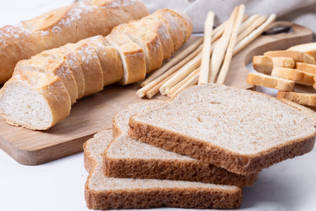 Assortment of Bread Products on white marble background