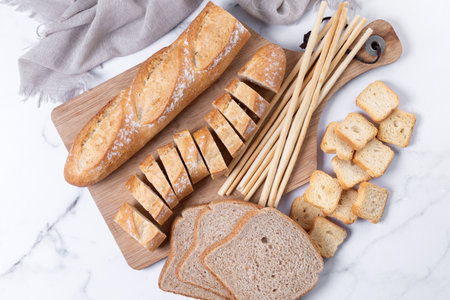 Assortment of Bread Products on white marble background