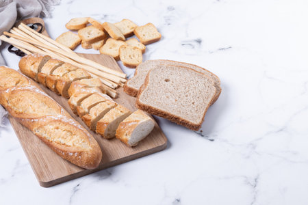 Assortment of Bread Products on white marble background