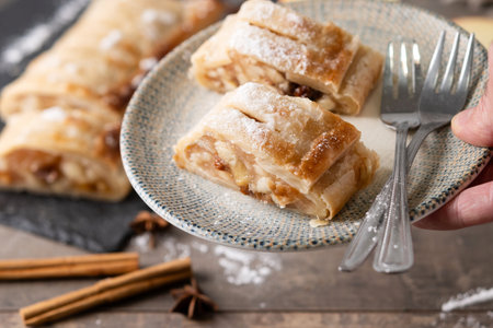 Homemade apple strudel slices on wooden tableの写真素材