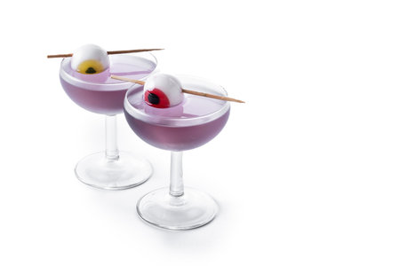 Halloween cocktail garnished with candy eye isolated on white backgroundの写真素材