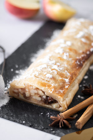 Homemade apple strudel on white marble background. Traditional Austrian and German sweetの写真素材