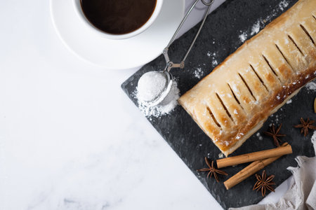 Homemade apple strudel on white marble background. Traditional Austrian and German sweetの写真素材