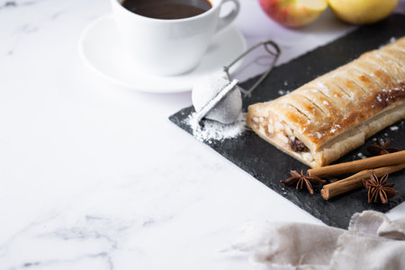 Homemade apple strudel on white marble background. Traditional Austrian and German sweetの写真素材