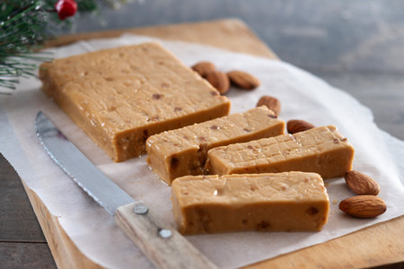 Soft almond nougat bar on wooden table