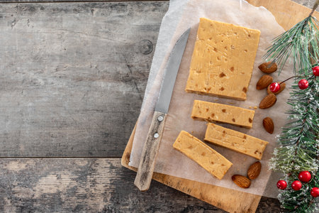 Christmas soft almond nougat bar on wooden tableの写真素材