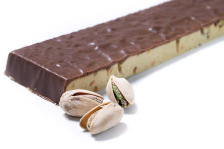 Chocolate pistachio nougat bar isolated on white backgroundの写真素材