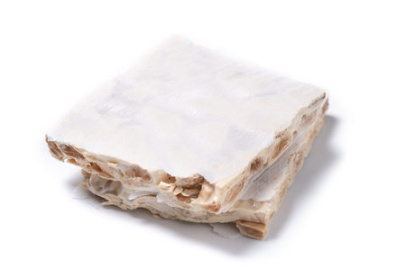 Delicious almond nougat isolated on white background. Traditional Christmas sweetの写真素材