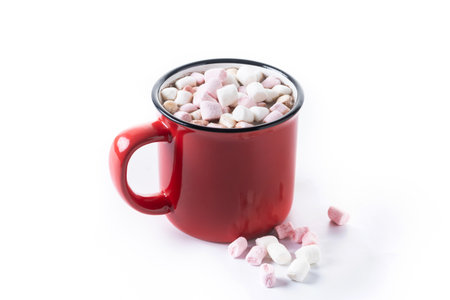 Hot chocolate drink with marshmallows in red mug isolated on white background