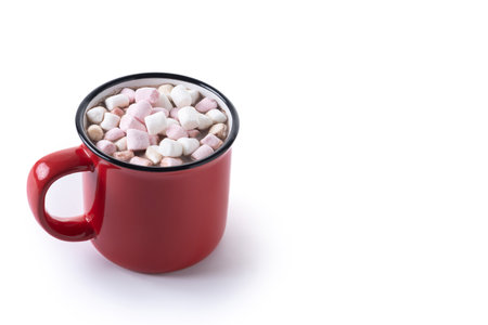 Hot chocolate drink with marshmallows in red mug isolated on white backgroundの写真素材