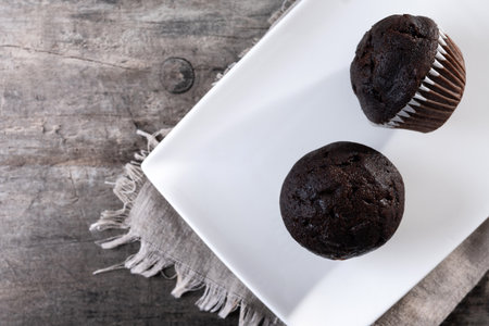 Chocolate muffins on wooden tableの写真素材