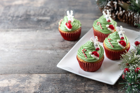 Christmas cupcake with christmas decoration on wooden tableの写真素材