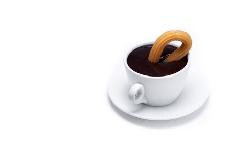 Spanish churros with hot thick chocolate in a white cup isolated on white backgroundの写真素材