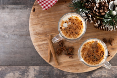 Eggnog with Cinnamon and Christmas Decorations on wooden tableの写真素材