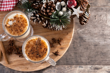 Eggnog with Cinnamon and Christmas Decorations on wooden tableの写真素材