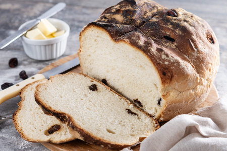 Traditional Irish soda bread with raisins, freshly baked and sliced on wooden table