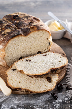 Traditional Irish soda bread with raisins, freshly baked on wooden table