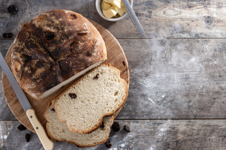 Traditional Irish soda bread with raisins, freshly baked on wooden table