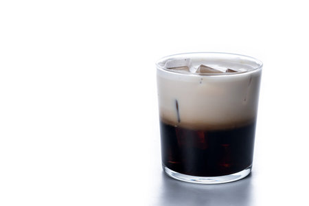 Refreshing Boozy White Russian Cocktail with Vodka and Cream isolated on white background