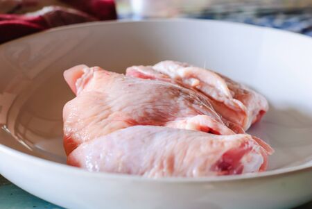 Fresh raw chicken meat on plate on tableの写真素材