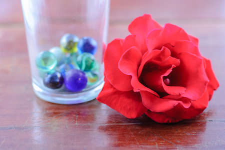 Close-up shot of a red rose on the tableの写真素材