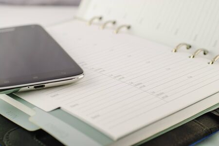 Office Supplies With Phone on the white tableの写真素材
