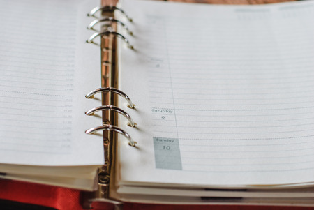 Open Notebook or Journal with blank lined pages for copyspace on a wood backgroundの写真素材