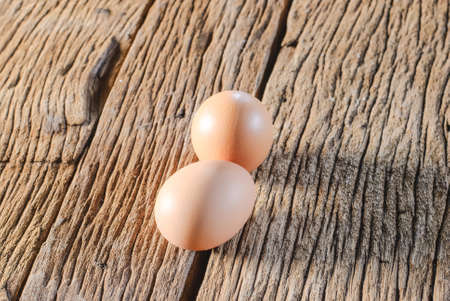 Fresh eggs in egg box in moody natural lighting vintage styleの写真素材