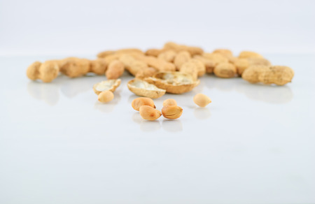 pile of peanuts in shell isolated over whiteの写真素材