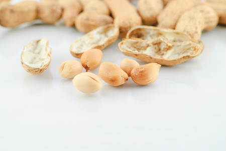 pile of peanuts in shell isolated over white