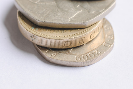 British one-pound coins on a white backgroundの写真素材