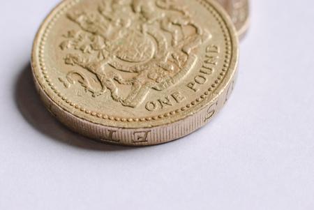 British one-pound coins on a white backgroundの写真素材